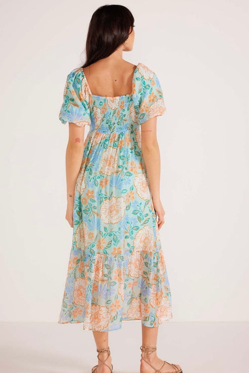 Model wears a blue floral maxi dress