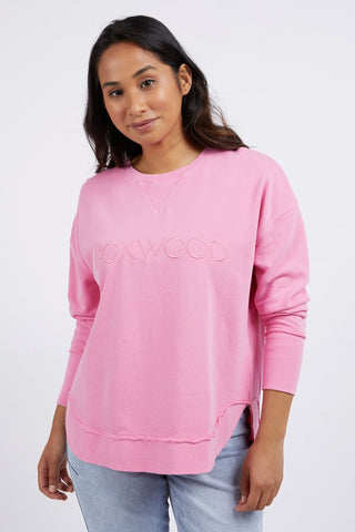 model wears a pink jumper