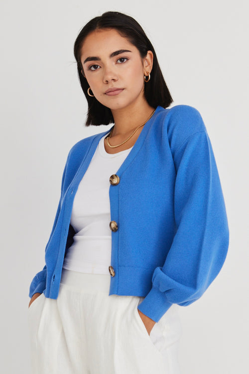 model wears a blue cardigan