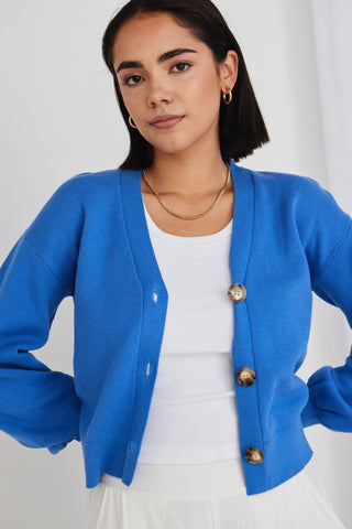 model wears a blue cardigan