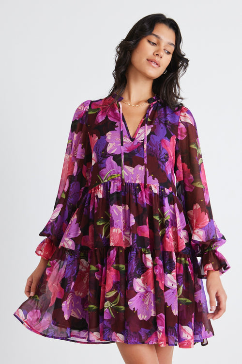 model wears a purple floral mini dress