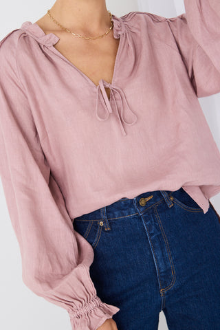 model wears a pink linen blouse