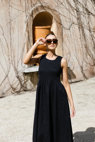 model posing in long black linen midi dress
