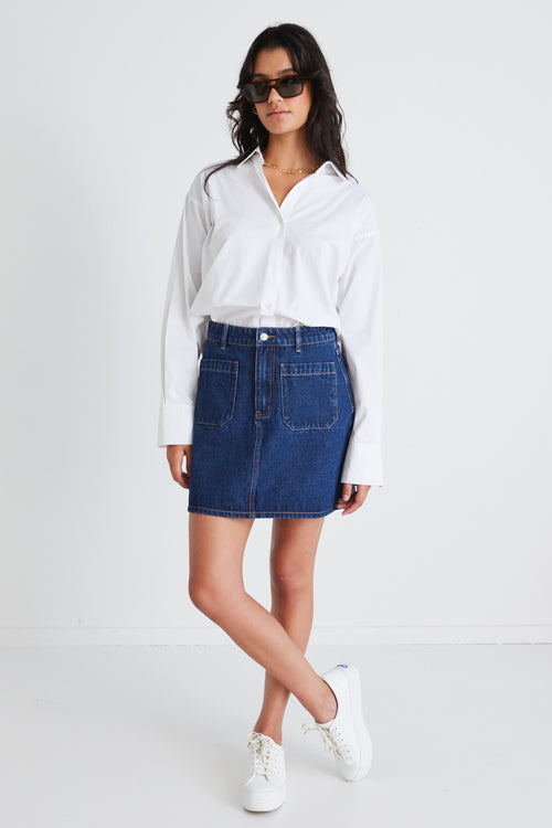 model wears a denim mini skirt