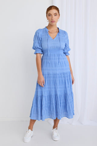 model wears a blue midi dress