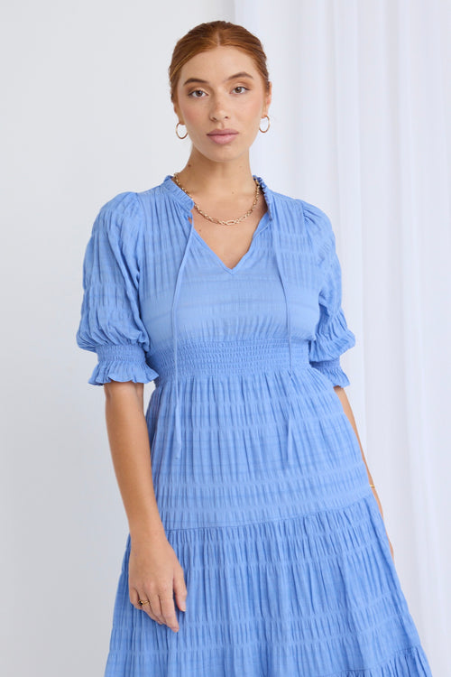 model wears a blue midi dress