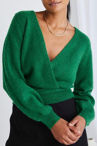 model wears a green wrap knit
