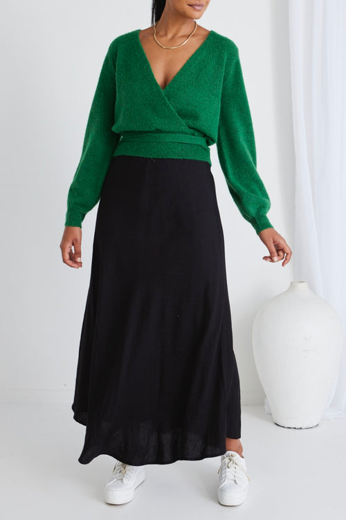 model wears a green wrap knit