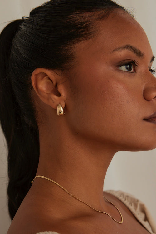 model wearing Chunky Oval Gold Earrings