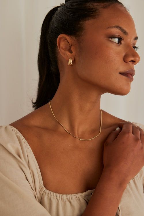 model wearing snake chain necklace