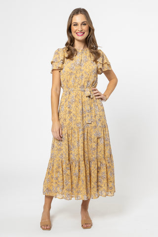model wears a yellow floral maxi dress