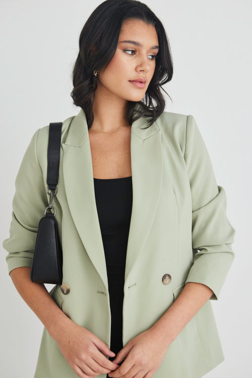 model wears a green blazer