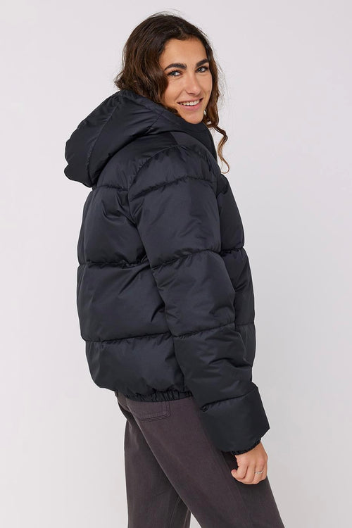 model wears a black puffer jacket