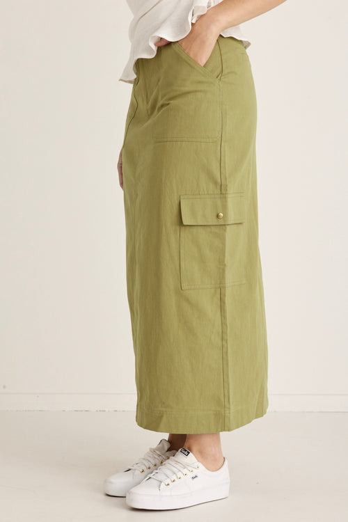 model wears a green skirt