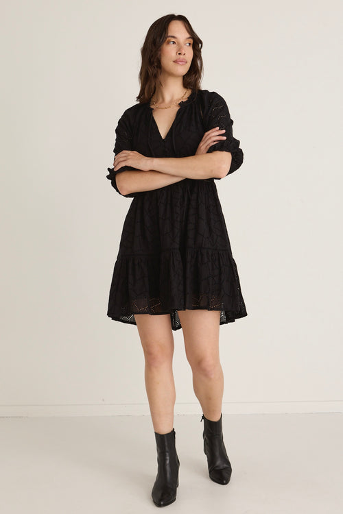 Model wears a black Mini Dress