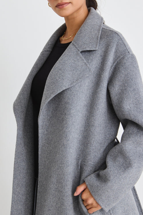 Model wears a grey wool coat