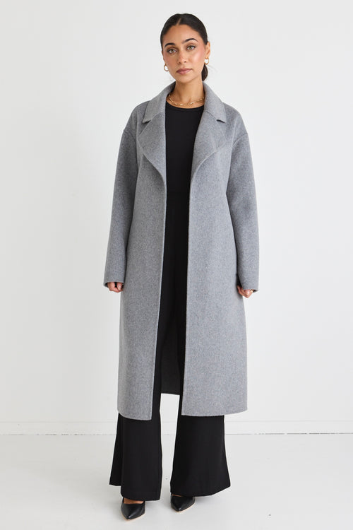 Model wears a grey wool coat