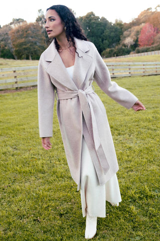 model wears a beige wool coat