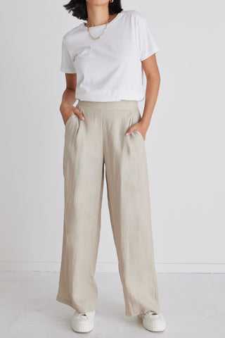 model wears beige linen pants
