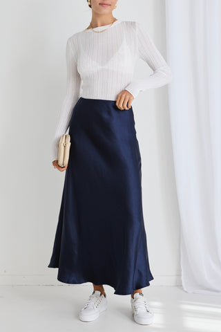 model wears a navy maxi skirt