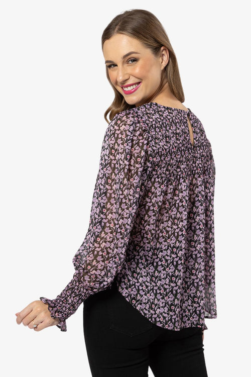 model in purple floral long sleeve top