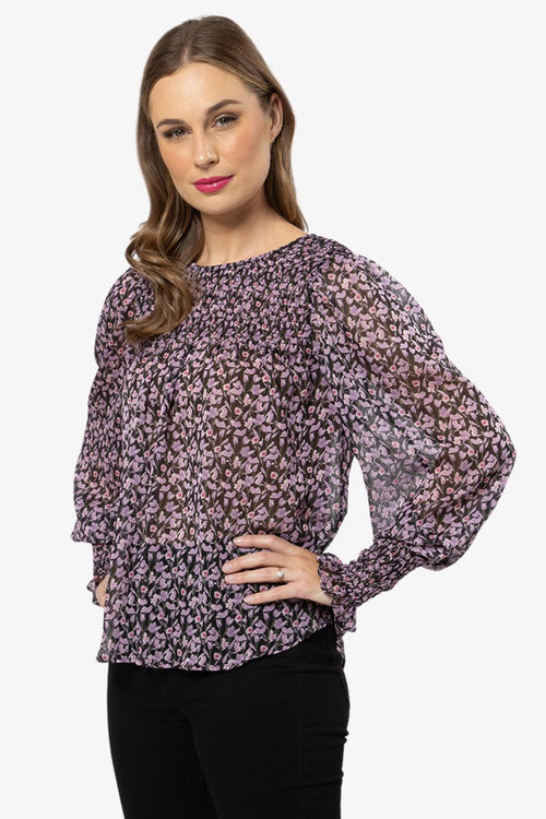model in purple floral long sleeve top