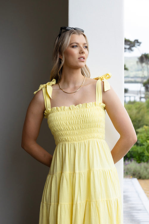 model wearing long yellow maxi dress