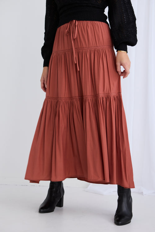 model wears a red maxi skirt