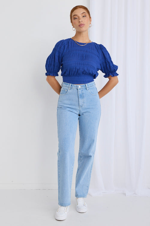 model wears a blue crop top 