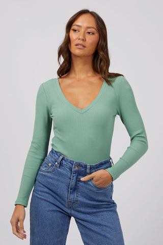 model wears a green rib long sleeve top