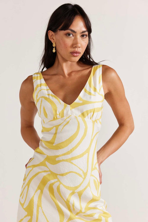 model wears yellow print maxi dress