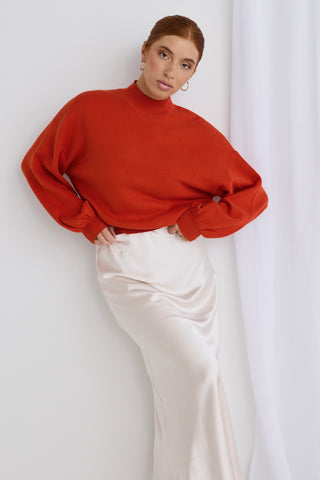 model wears a red knit