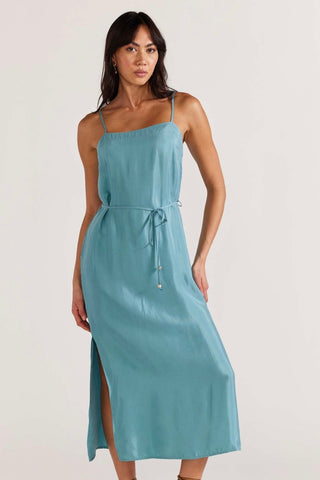 model wears a blue slip dress