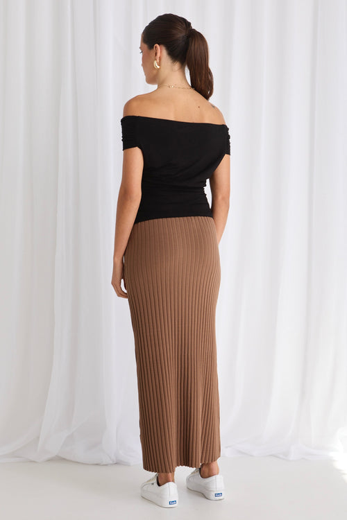 model wears a brown rib knit skirt