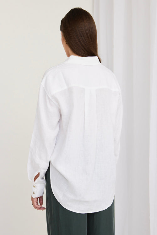 model wears a white linen shirt