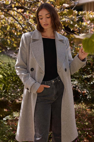 model wears a grey coat