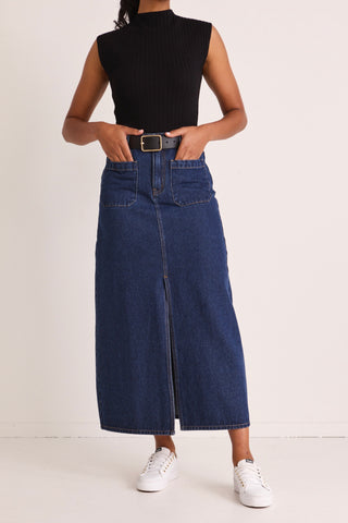 model wears a blue denim maxi skirt