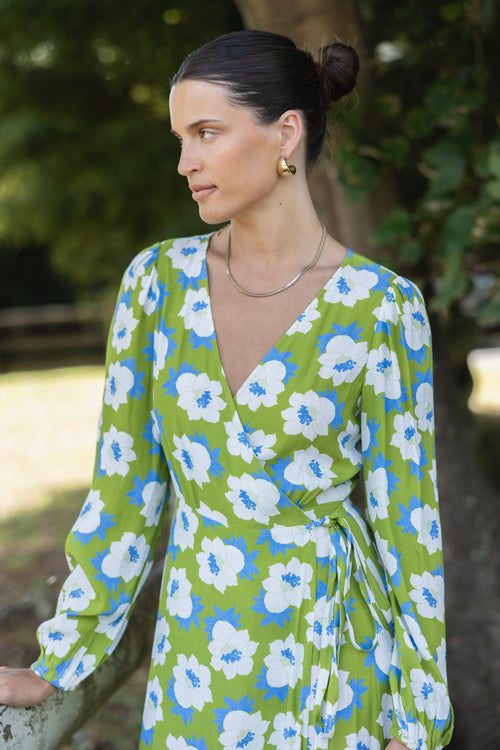 model wears a long sleeve green floral maxi dress