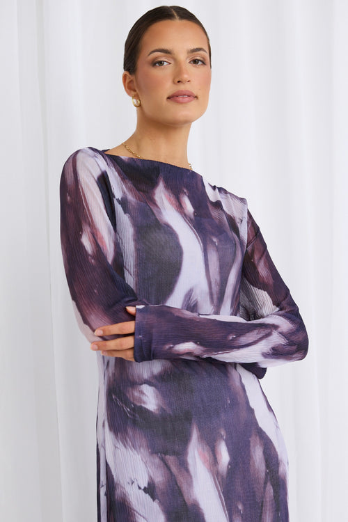 model wears a purple mesh dress