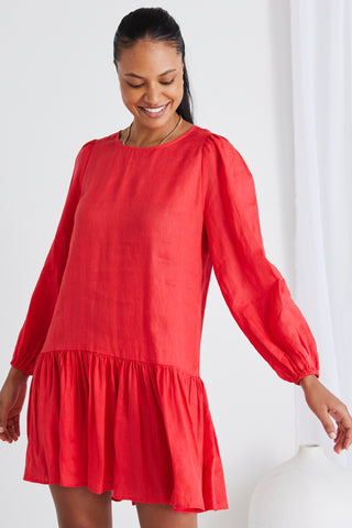 model wears a red long sleeve dress