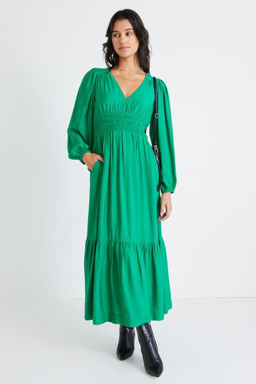 model wears a green dress