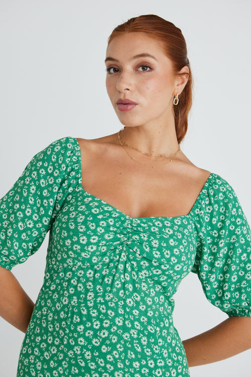 Model wears a green floral print maxi dress.  