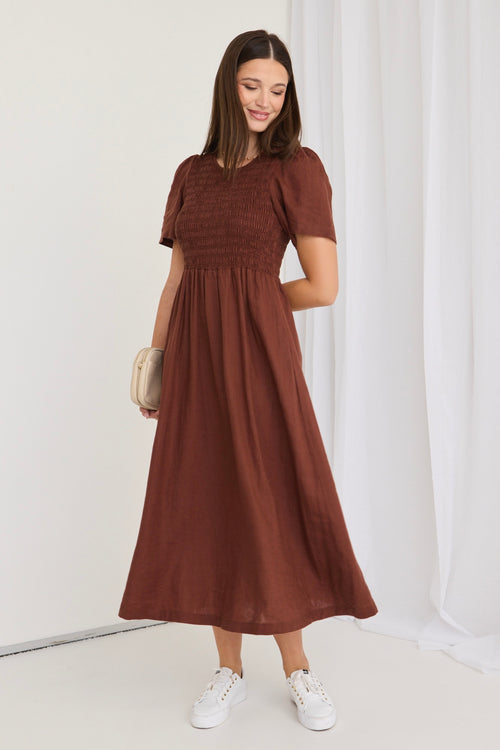 model wears a brown midi dress