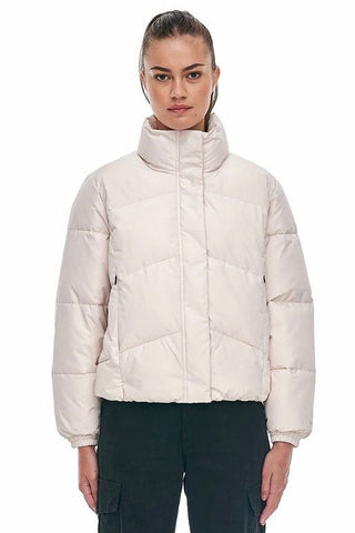 model wears a white puffer jacket