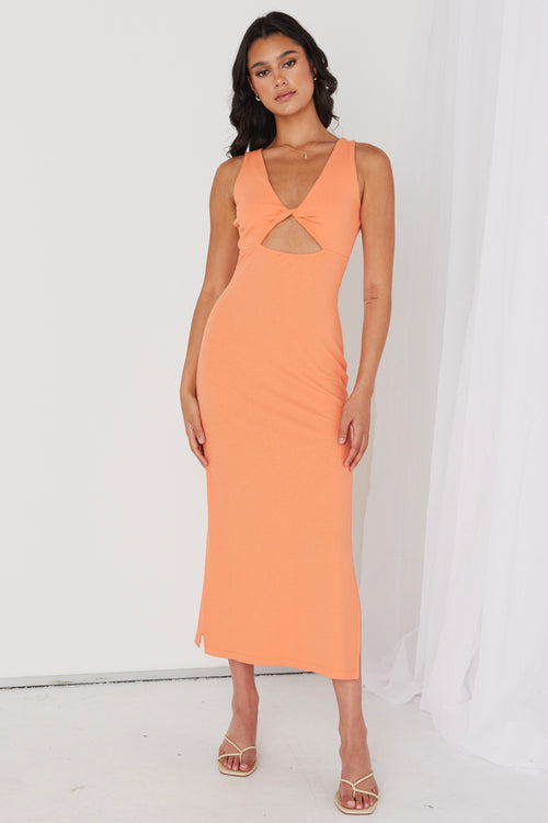 model in orange ribbed midi dress and heels
