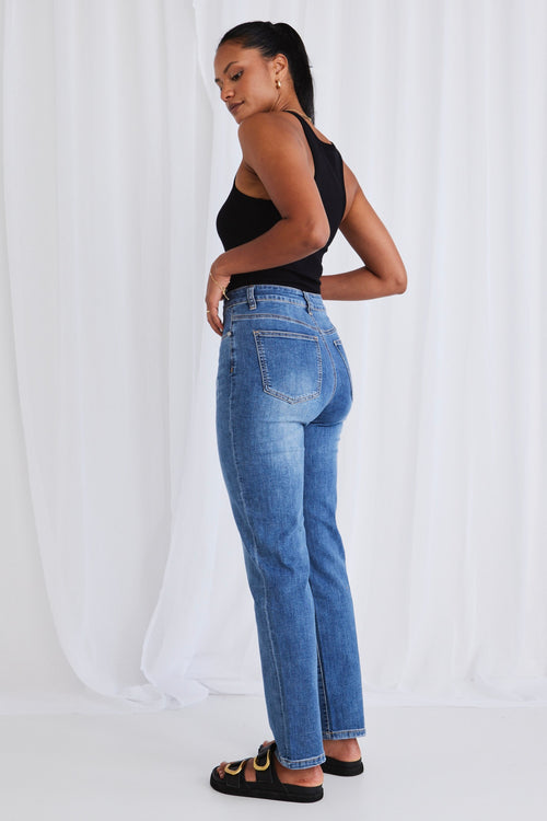 model wears dark blue jeans 
