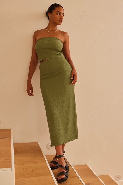Model wearing green bandeau top and maxi skirt set