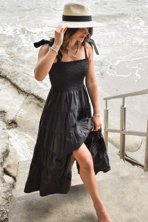 model posing outside in long black maxi dress
