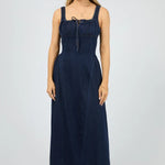 Woman wearing a navy blue dress on a white background