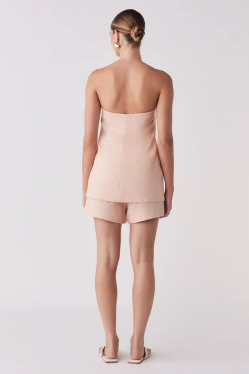 Woman wearing a pink sleeveless button down vest